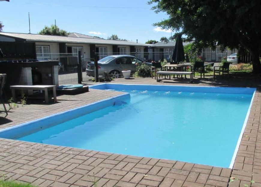 Crystal-clear swimming pool for guests to enjoy at Hastings motel
